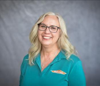 female employee in front of green background