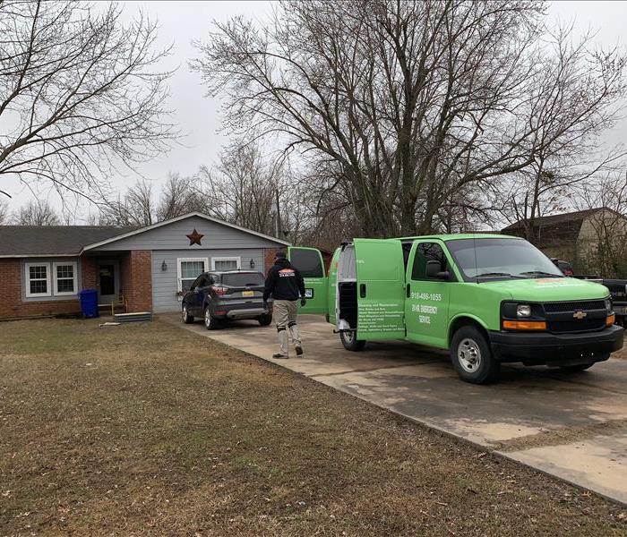 One of our team members walking into a house with water damage